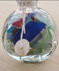 SET OF 2 BOTTLES OF SEA GLASS AS SHOWN