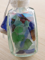 SET OF 2 BOTTLES OF SEA GLASS AS SHOWN