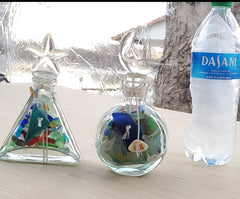 SET OF 2 BOTTLES OF SEA GLASS AS SHOWN